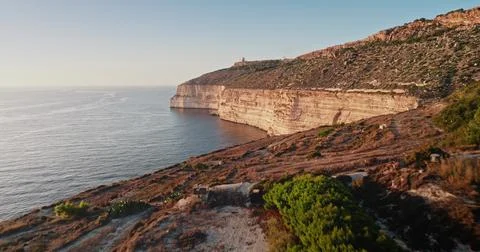 Dingli Cliffs illuminated by golden sunset light in Malta Stock Photos