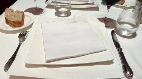 Dining area featuring with table setting, evoking clean and stylish atmosphere. Stock Footage 297620778