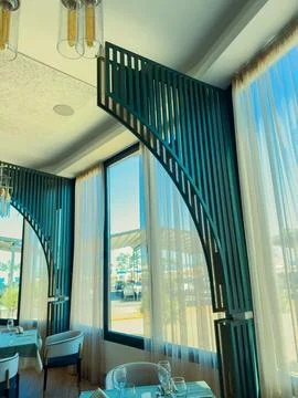 Dining area in a restaurant with large windows and stylish design near the .. 스톡 사진