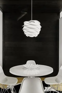 Dining Area With Round White Table, Unique Light Fixture, And White Chairs. Stock Photos