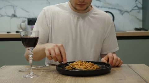 Dining Experience Savoring Delicious Pasta Paired with Red Wine Stock Footage 307794575