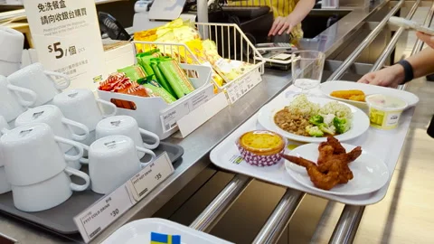 Dining at IKEA: Tray of Delights at the Checkout Counter Stock Footage 293467021