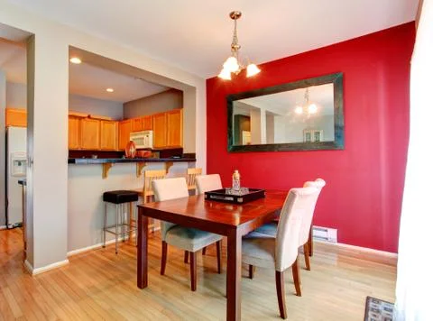 Dining room with contrast red wall Stock Photos