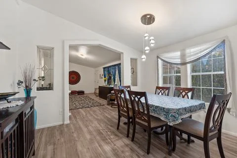 A dining room featuring a table accompanied by chairs in a house Stock Photos
