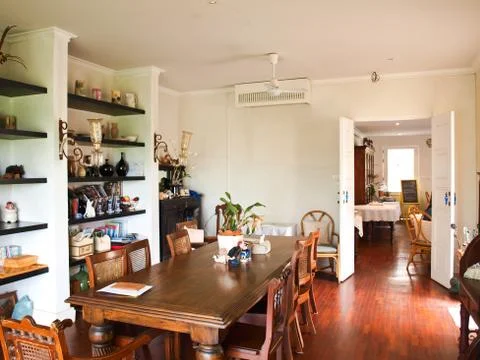 Dining room interior with classic brown furniture and natural light. Stock Photos