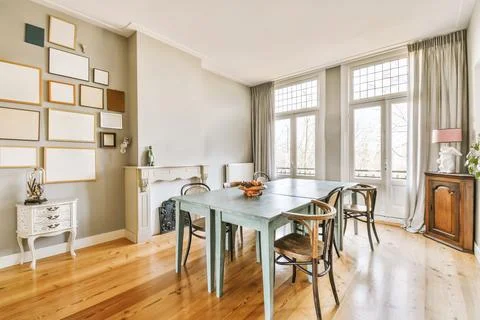 A dining room with a long blue table and chairs 写真素材