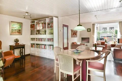 A dining room with a table and chairs and a Stock Photos
