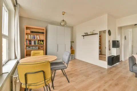 A dining room with a table and chairs Stock Photos