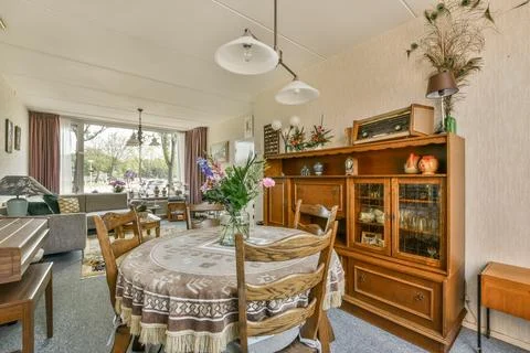 A dining room with a table and chairs Stock Photos