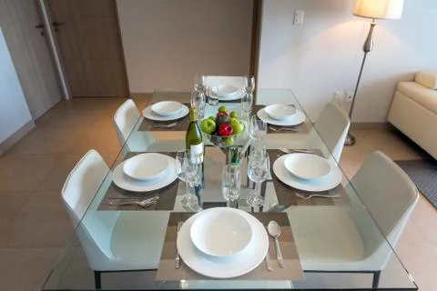 Dining room with a table for dinner with fruit. Stock Photos