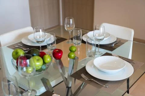 Dining room with a table for dinner with fruit. Stock Photos