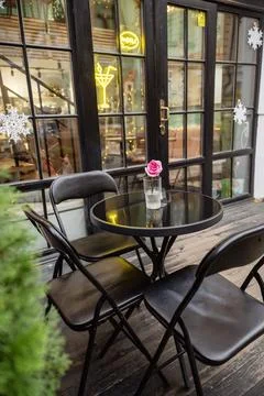 A dining room table in front of a window Stock Photos
