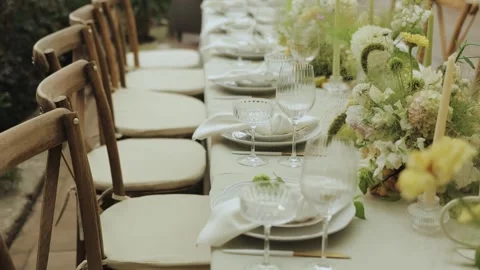 Dining Setup Adorned with Beautiful Floral Arrangements and Decor. Wedding decor Stock Footage 306156503