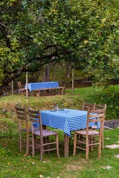 Dining table and chairs set outside Stock Photos