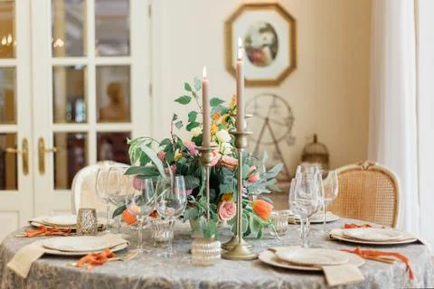 A dining table and comfortable armchairs in a modern house with a light dining Stock Photos