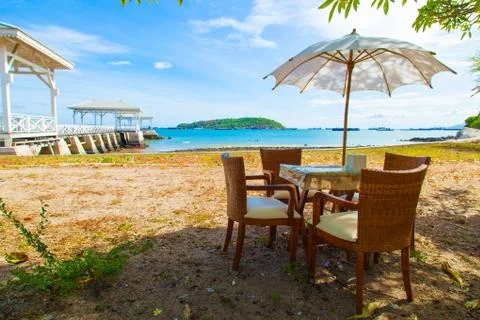 Dining table and umbrella. Stock Photos