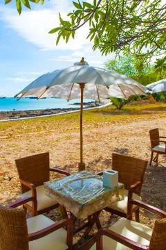 Dining table and umbrella. Stock Photos