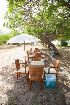 Dining table and umbrella. Stock Photos