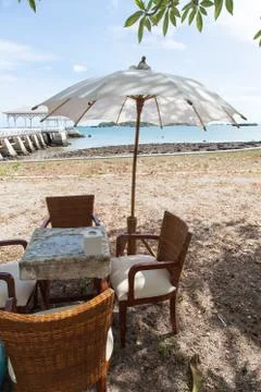 Dining table and umbrella. Stock Photos