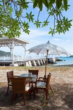 Dining table and umbrella. Stock Photos