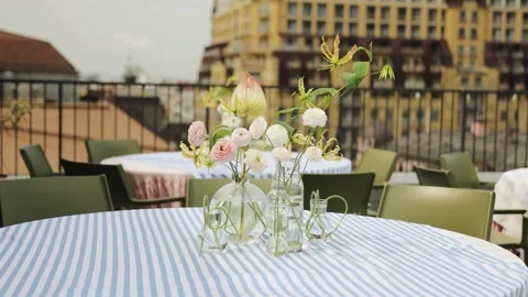 Dining table with a blue tablecloth outdoors in a restaurant, decorated with Stock Footage 318066101