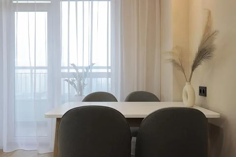 Dining table with chairs in the kitchen interior Stock Photos