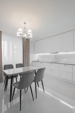 Dining table with chairs in the kitchen interior Stock Photos