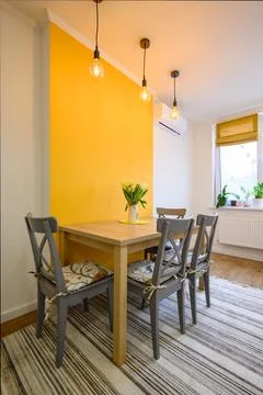 Dining table in cozy well designed dining room Stock Photos