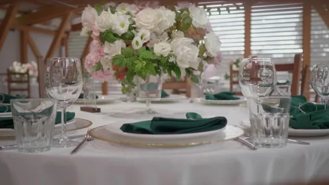A dining table decorated with flowers in a bright and beautiful hall Stock Footage 185389880
