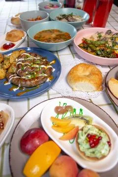 A dining table with different food served in a cafe or restaurant Stock Photos