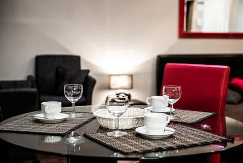 Dining table with the empty coffee cups and glasses Stock Photos