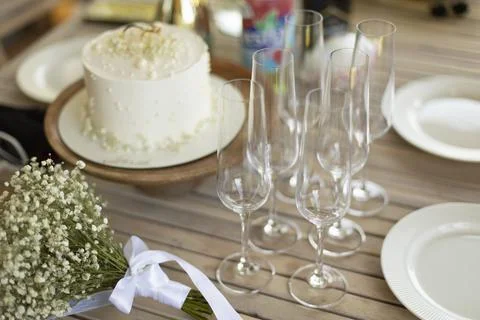 Dining table. Festive table with empty glasses. Sweet cake in summer. Stock Photos