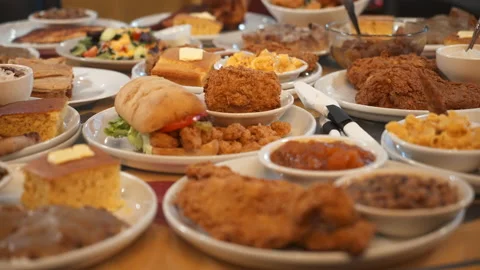 Dining table filled with plates of unhealthy fried food, slider 4K Stock Footage 170382695