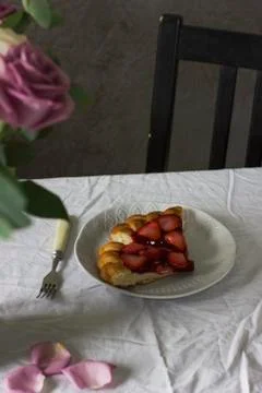 Dining table with flowers and strawberry pie, rustic style Stock Photos