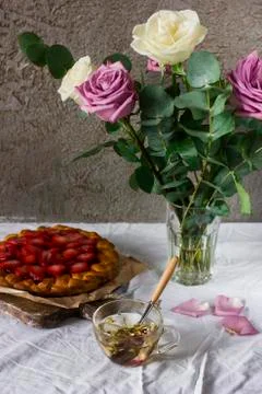 Dining table with flowers and strawberry pie, rustic style Stock Photos