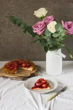 Dining table with flowers and strawberry pie, rustic style Stock Photos