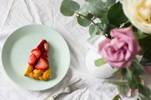 Dining table with flowers and strawberry pie, rustic style Stock Photos