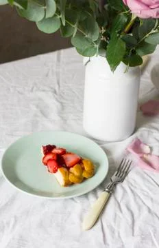 Dining table with flowers and strawberry pie, rustic style Stock Photos