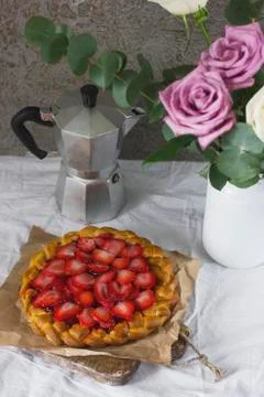 Dining table with flowers, coffee maker and strawberry pie, rustic style Stock Photos
