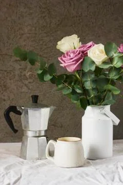 Dining table with flowers, coffee maker and cup, rustic style Stock Photos