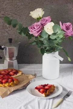 Dining table with flowers, coffee maker and strawberry pie, rustic style Stock Photos