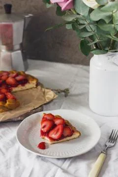 Dining table with flowers, coffee maker and strawberry pie, rustic style Stock Photos
