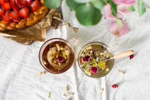 Dining table with flowers, herbal tea and strawberry pie, rustic style Stock Photos