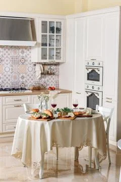 Dining table with food is in the kitchen. Stock Photos