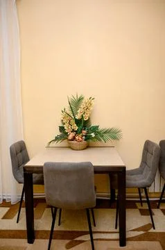 A dining table with four gray chairs Stock Photos