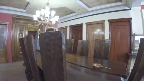 Dining table lined by high back chairs Stock Footage 97226717