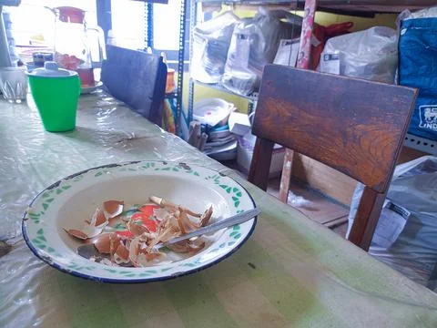 The dining table is in a mess. A messy dining table with used dishes and full Stock Photos
