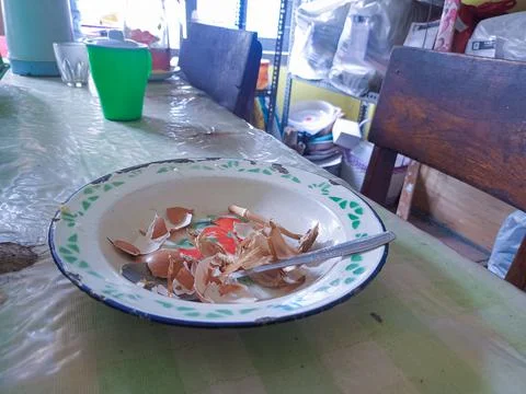 The dining table is in a mess. A messy dining table with used dishes and full Stock Photos