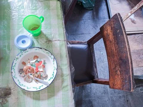 The dining table is in a mess. A messy dining table with used dishes and full Stock Photos