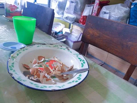 The dining table is in a mess. A messy dining table with used dishes and full Stock Photos